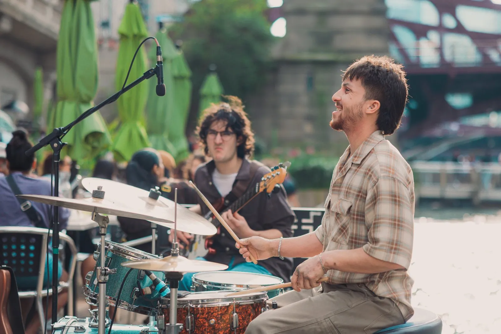 Paris Catura playing drums at an outdoor gig in Chicago